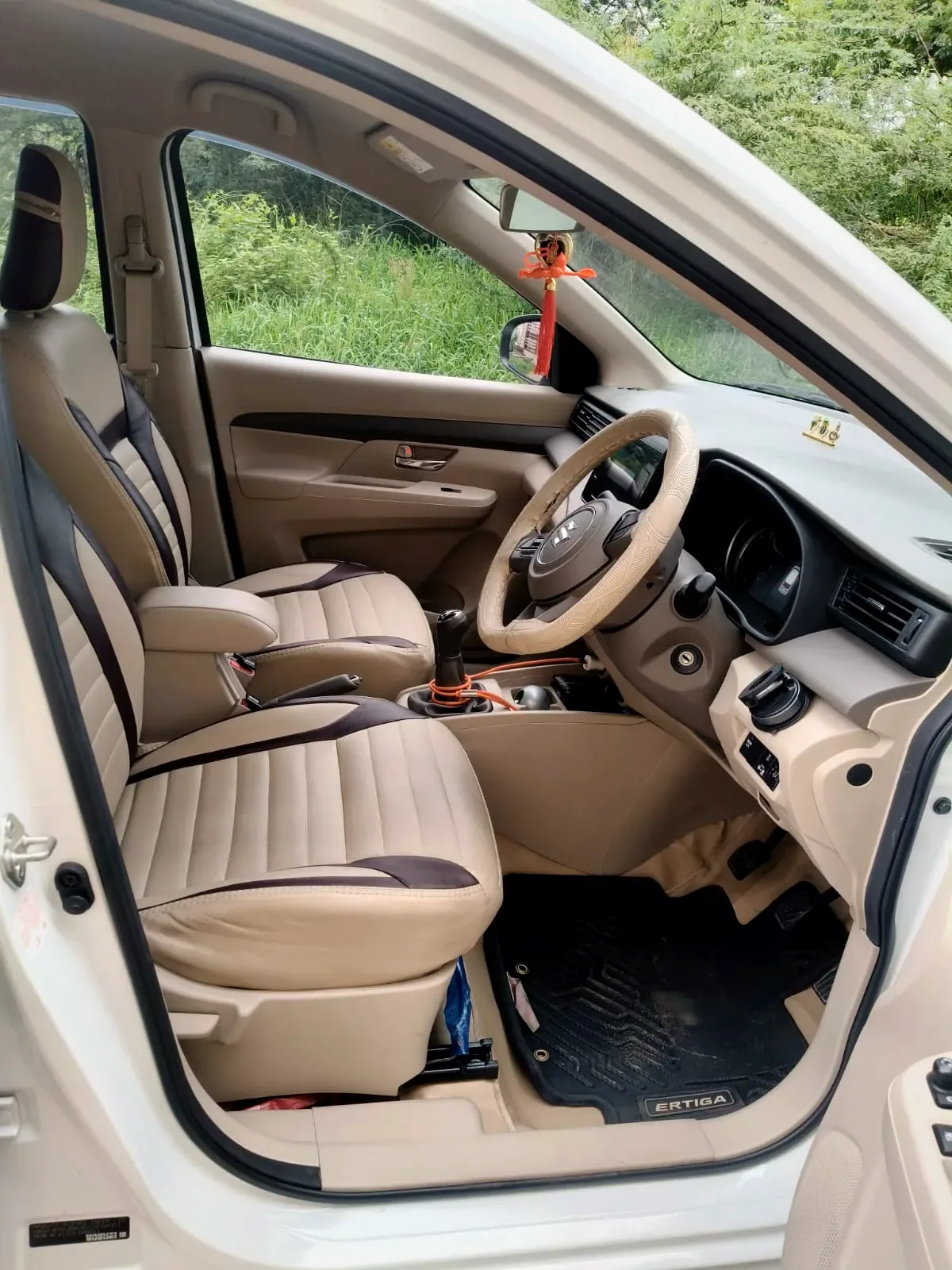 Ertiga front cabin — beige seats and dashboard